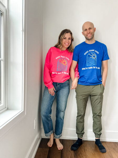 Leah and her husband wearing T-shirts she created for her Save Destination Healthy Skin fundraiser.
